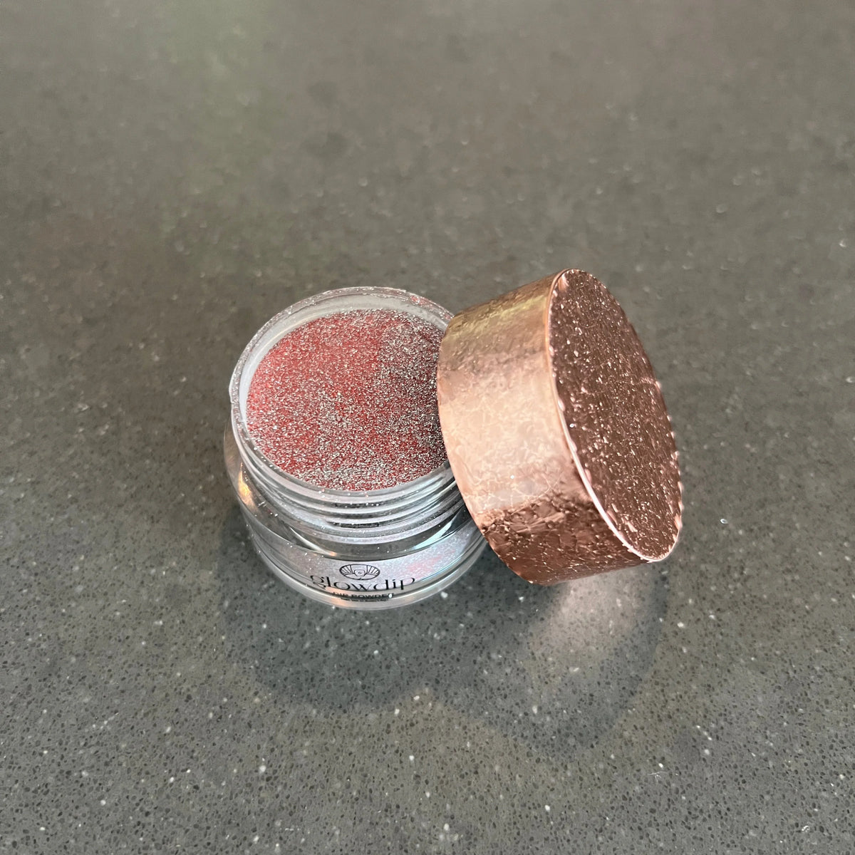 Limited edition 11 fire flash dipping powder in a rose gold glittery cosmetic pot with textured lid by glowclip