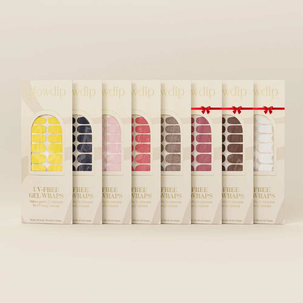 Een rij van zes creamkleurige dozen met verschillende gekleurde en patroon uv-vrije gel nagelwraps van glowdip bundle